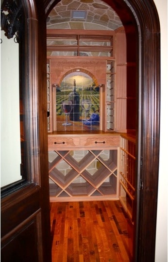 Planning to start your own project? Request a 3D wine cellar design for FREE! Doorway of Wine Room Showing Wine Barrel Flooring and Wood Racking