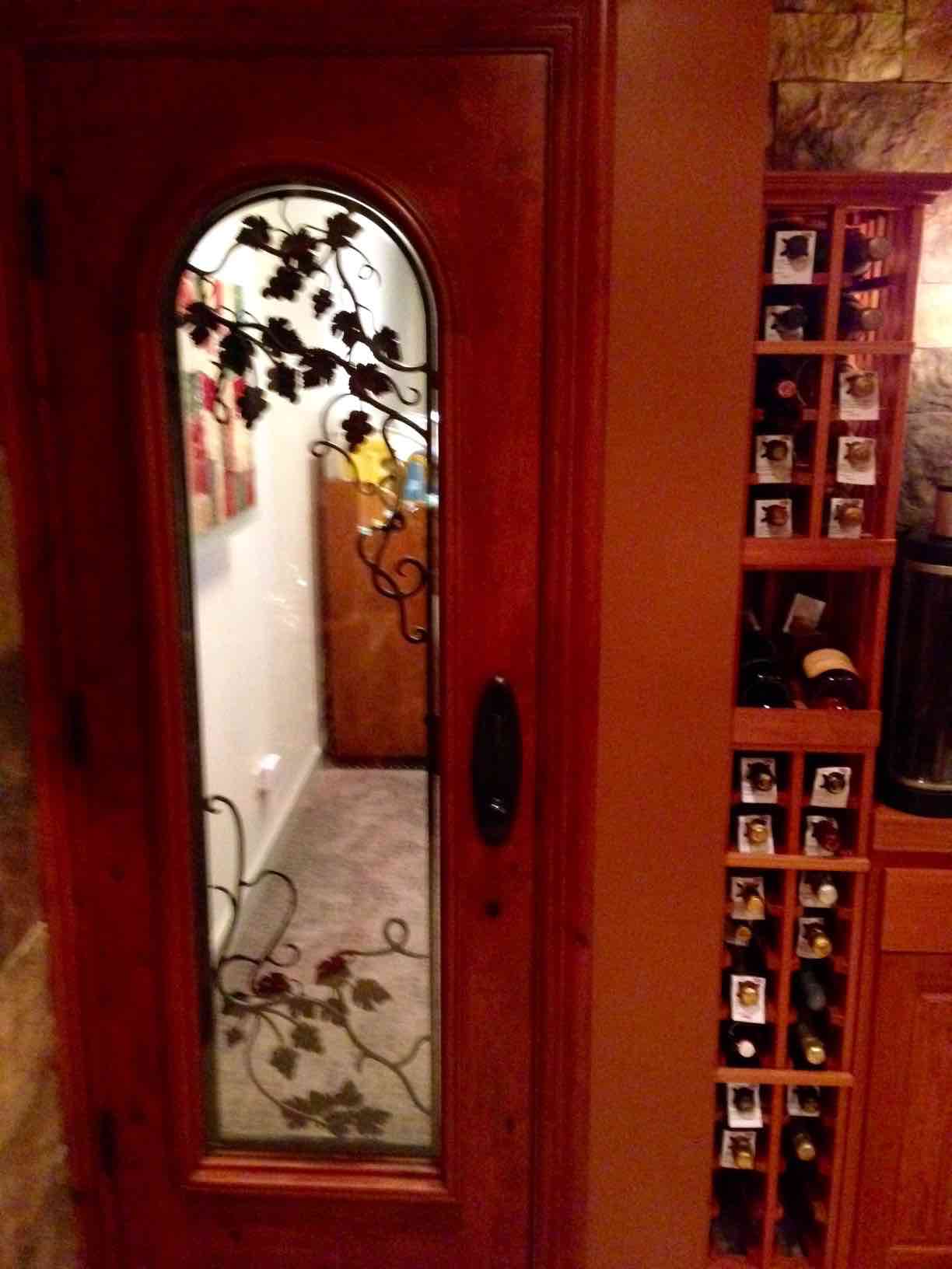 Custom Wine Cellar Door with Wrought Iron Grapevine Design Florida Builer